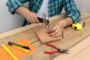 hands using hammer and nails and other hand tools