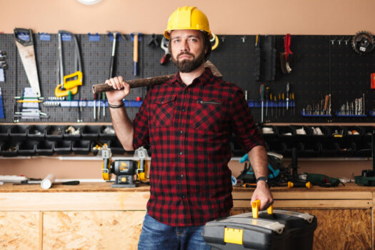 Homeowner working in a clean garage workshop with Essential DIY Tools
