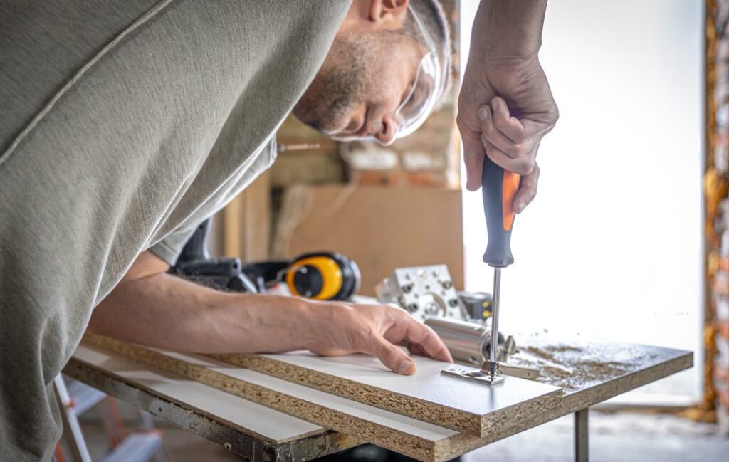 homeowner using screwdriver
