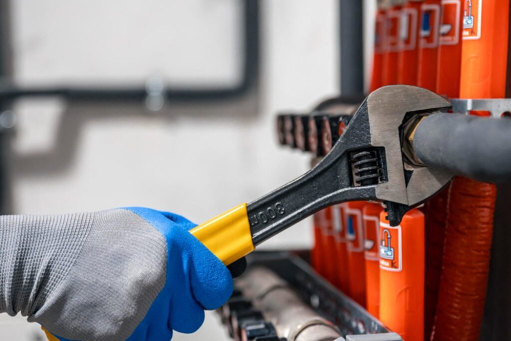 Adjustable wrench tightening plumbing fitting